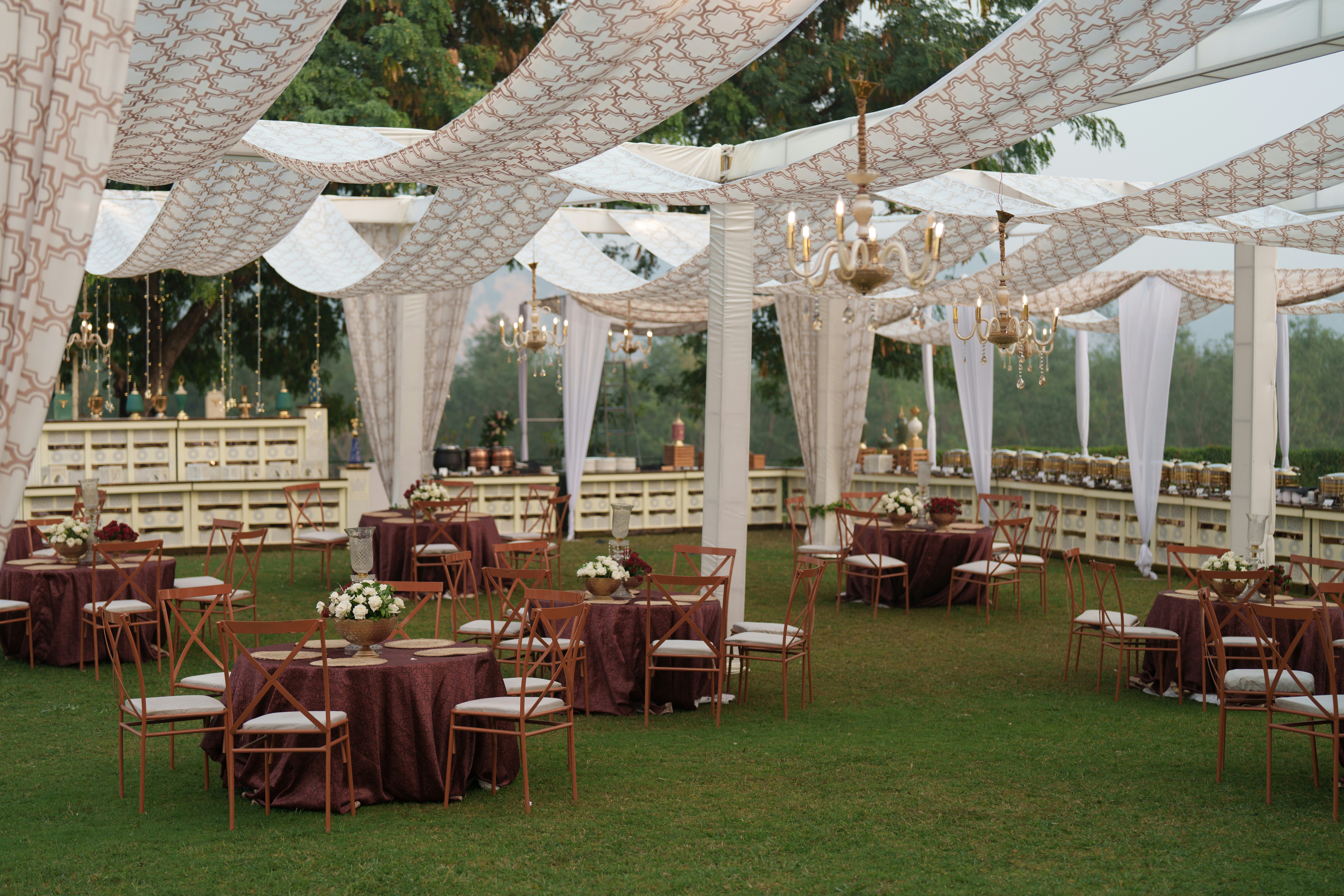 Candlelit dinner reception table with glassware and warm string lights