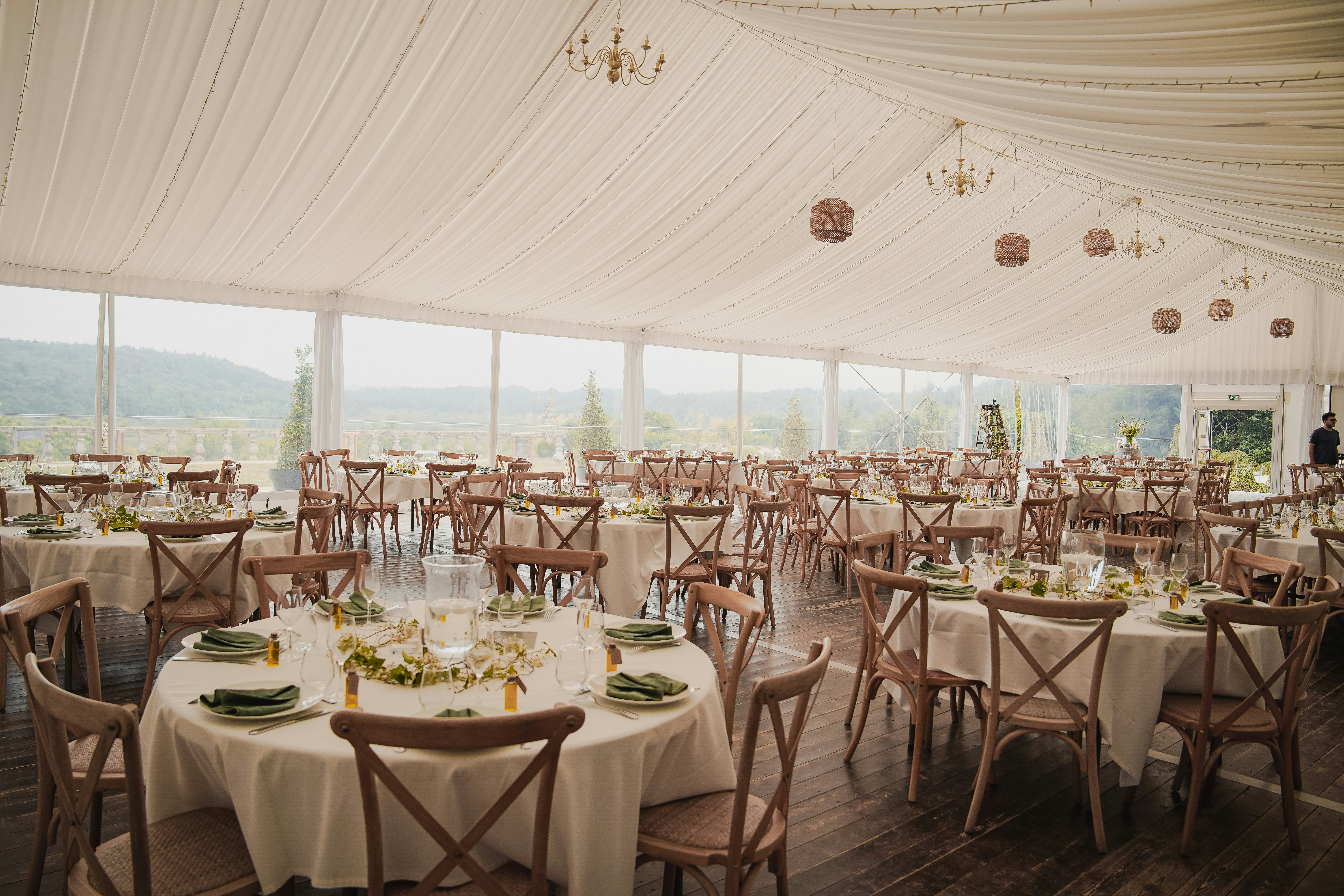 Night event terrace with string lights, lounge seating, and stage lighting