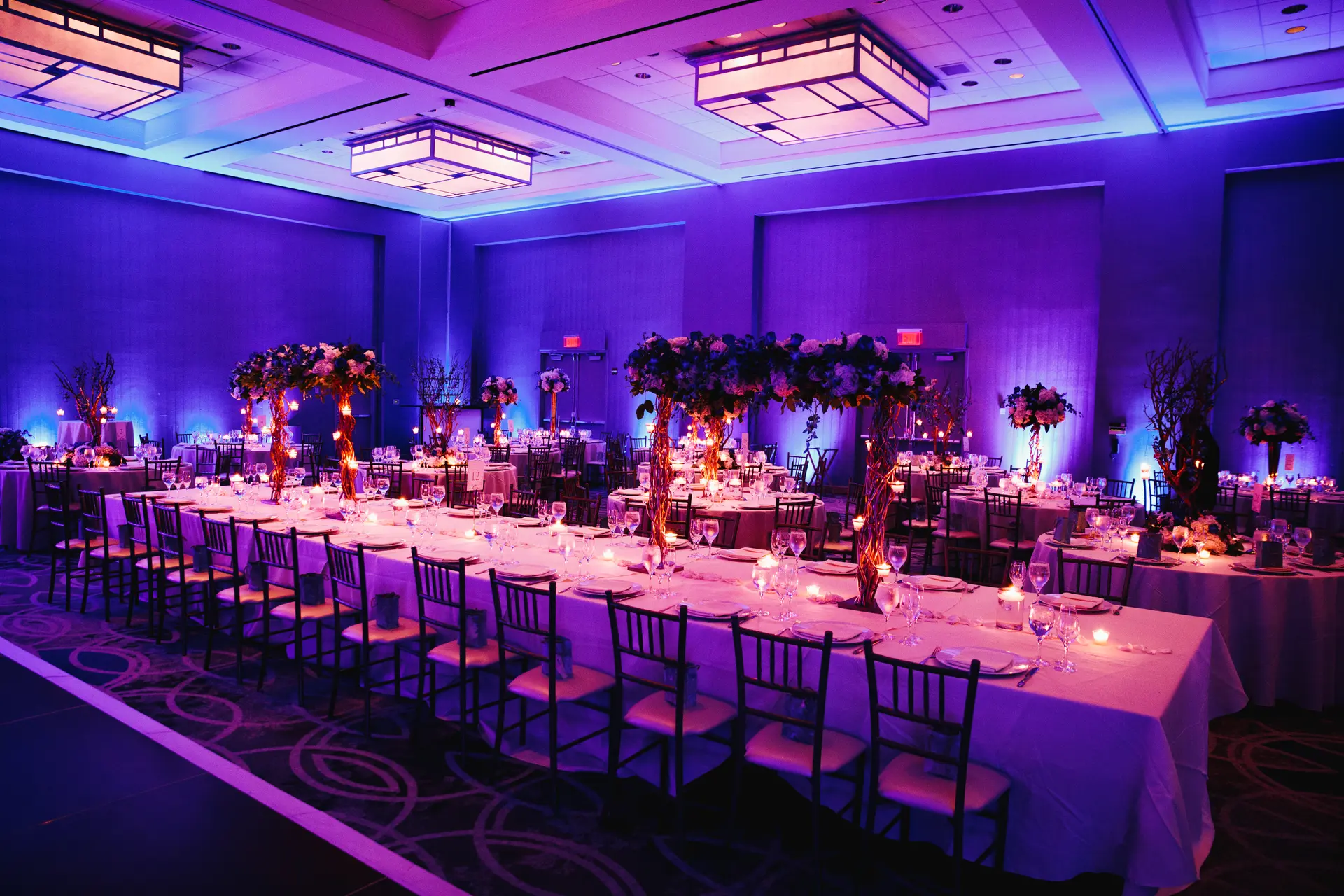 Decorated banquet hall setup with floral accents and ambient lighting